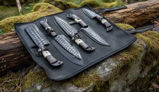 A set of 5 kitchen knives with wooden and bone handles, displayed in a black suede leather roll.