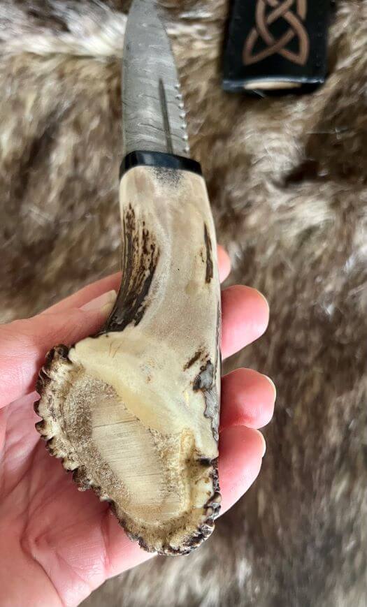 Hand forged sgian dubh with a unique crown stag handle, showcasing craftsmanship and natural materials.