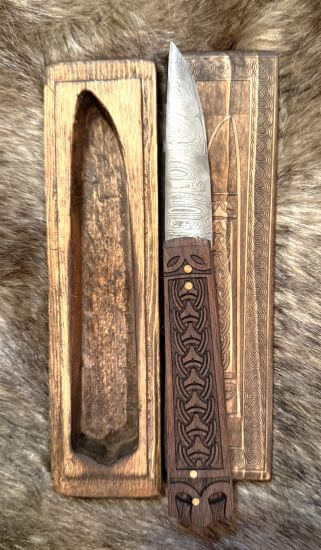 Viking Folding Knife Replica displayed in its wooden case, showcasing intricate craftsmanship and historical design.