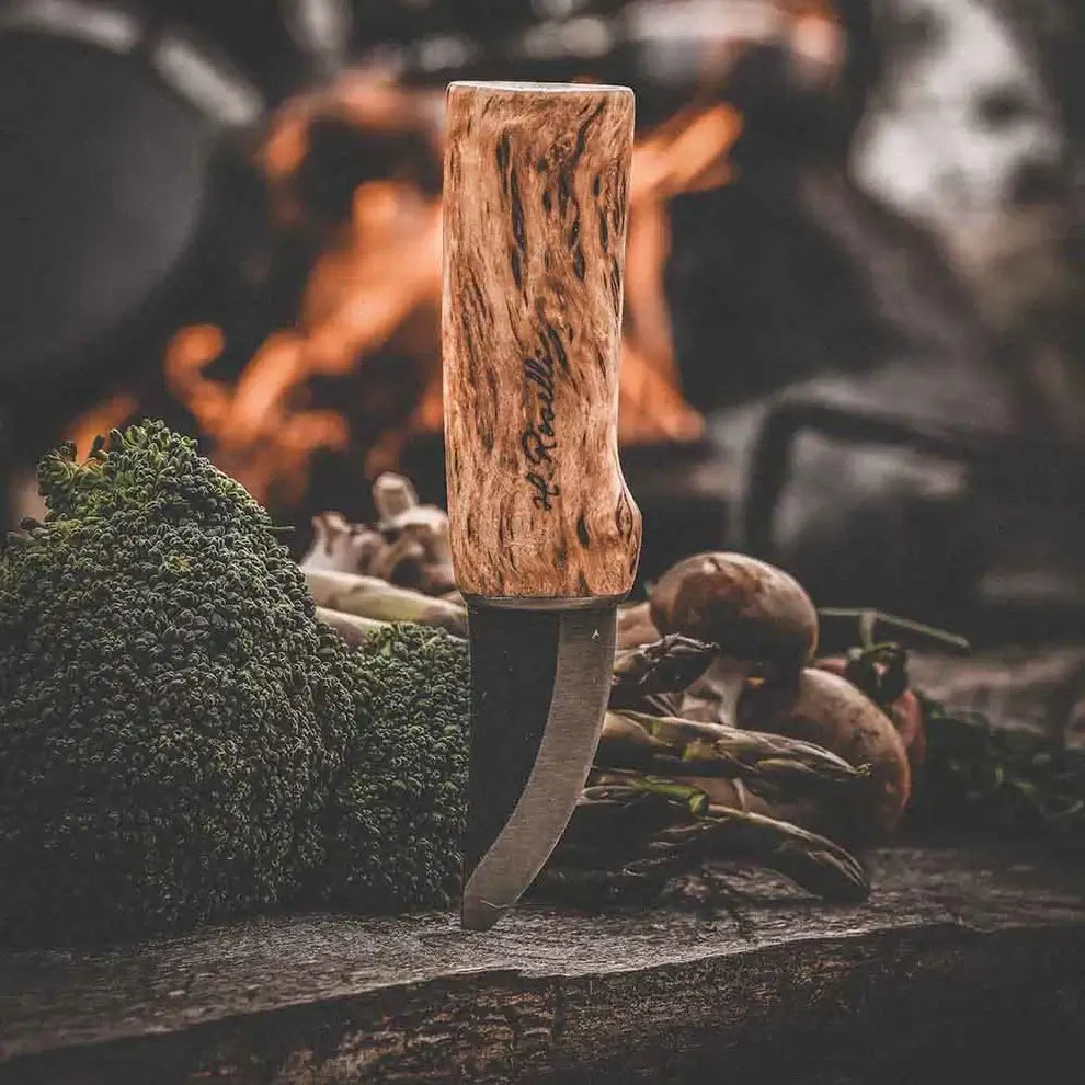 Roselli R120 The Grandfather Knife with Plain Sheath displayed with vegetables on a rustic table.