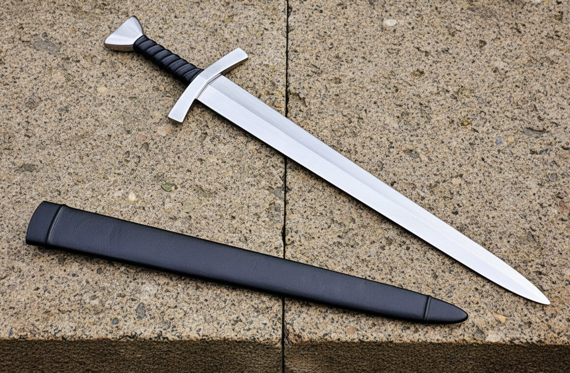 A replica of a Bowman's Short Sword from the Middle Ages with a wood lined leather covered scabbard. The blade is made from carbon steel and has a sharp edge.