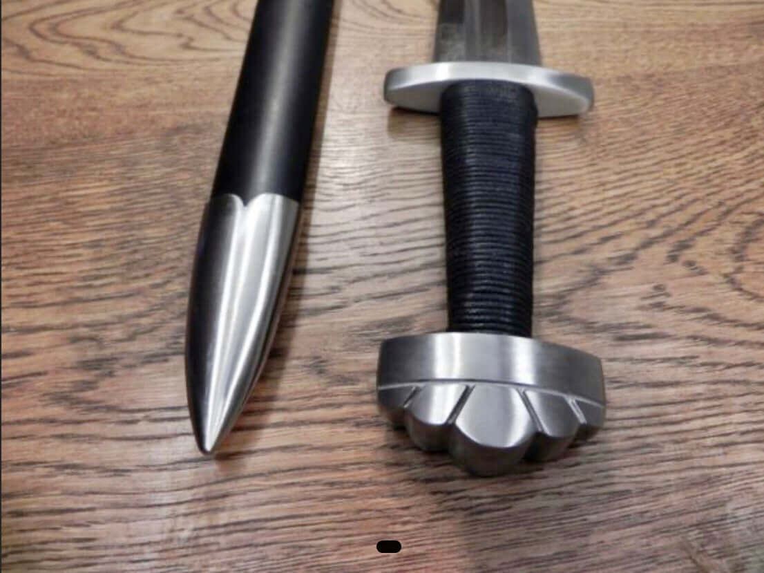 Viking sword Kawashima featuring five lobed pommel and cord wrapped grip, alongside its black wood sheath with metal tip.