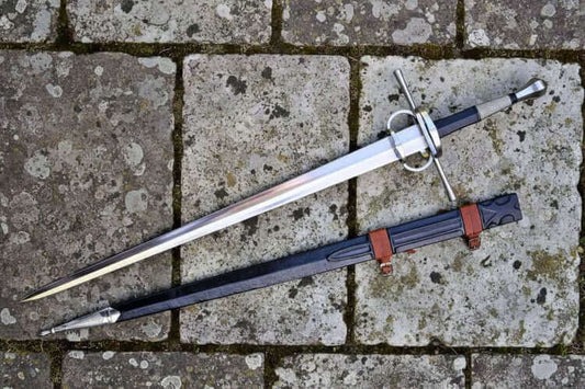 Two gothic bastard swords displayed on a stone surface, showcasing their design in The Gothic Bastard Sword Guide.