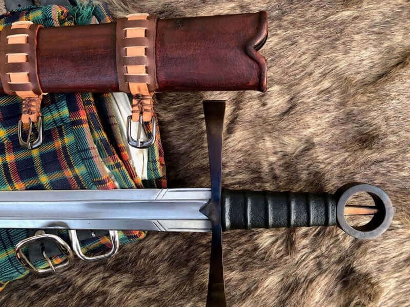 Irish Kern Warriors history: traditional sword and scabbard displayed on a textured surface.