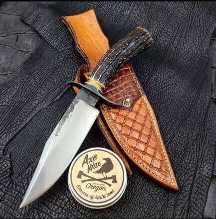 What Made Viking Swords and Knives Unstoppable in Battle? knife displayed with leather sheath and care product.