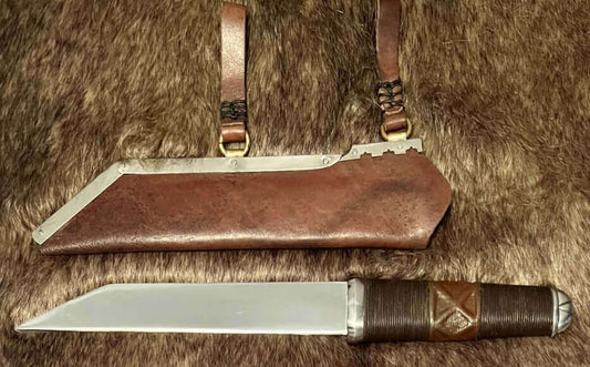 What the Seax knife displayed with its sheath, showcasing historical craftsmanship and design.