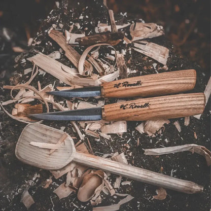 Roselli R113D The Carving Knife (Short Blade)- Red Elm placed on a wood surface with shavings.