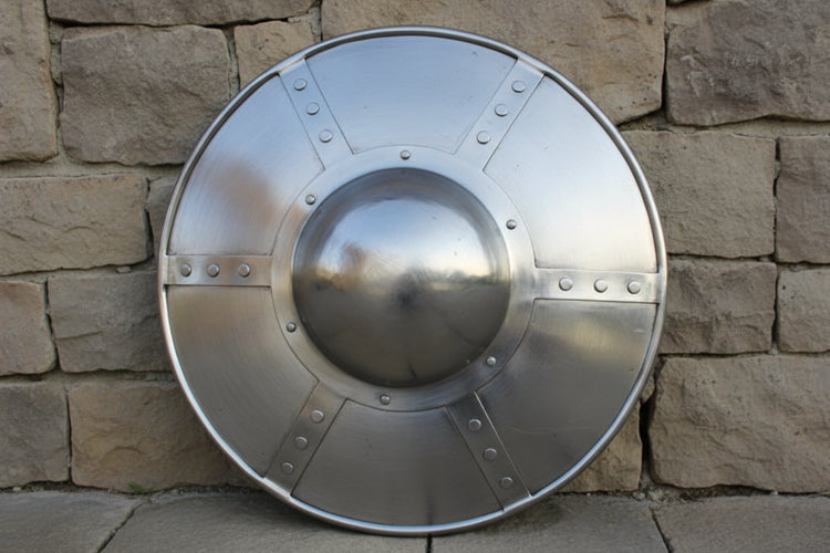 14 inch Hammered Steel Buckler Medieval Shield displayed against a stone wall.