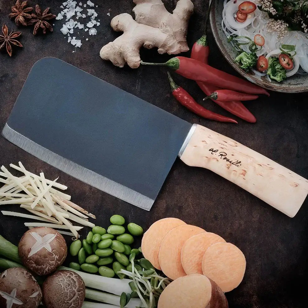 Roselli R730 Chinese Chef Knife with carbon steel blade and curly birch handle, surrounded by fresh ingredients.