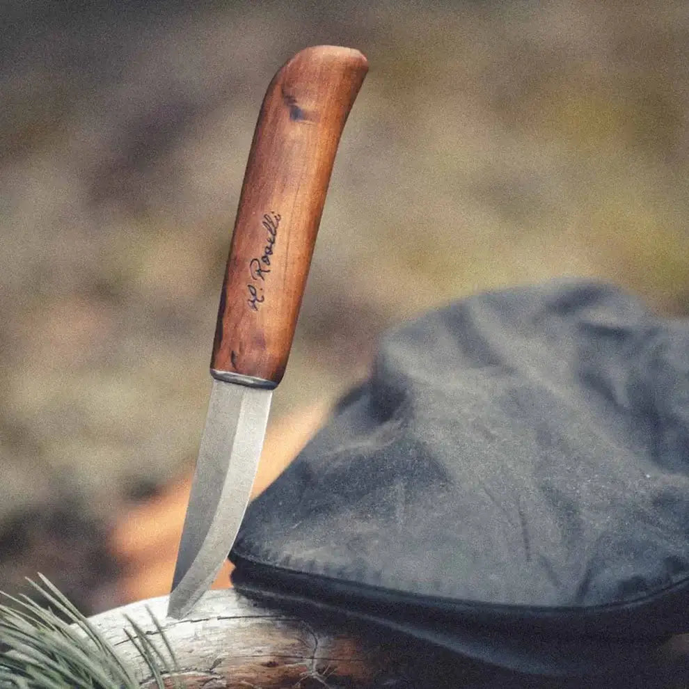 Roselli RW210 Carpenter's Knife, UHC Steel handmade in Finland with curly birch handle on a log.