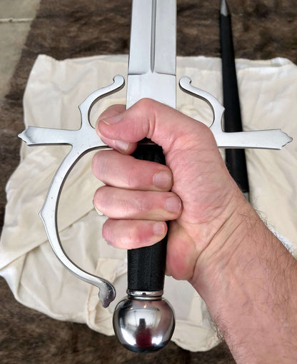 Hand gripping the hilt of the Sidesword and Buckler Shield Combo by Kingdom Of Arms and MAA.