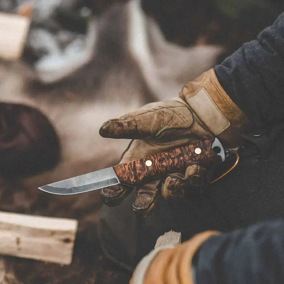 Roselli R40 Heimo 4" Bushcraft Hunting Edition knife held in gloved hand outdoors