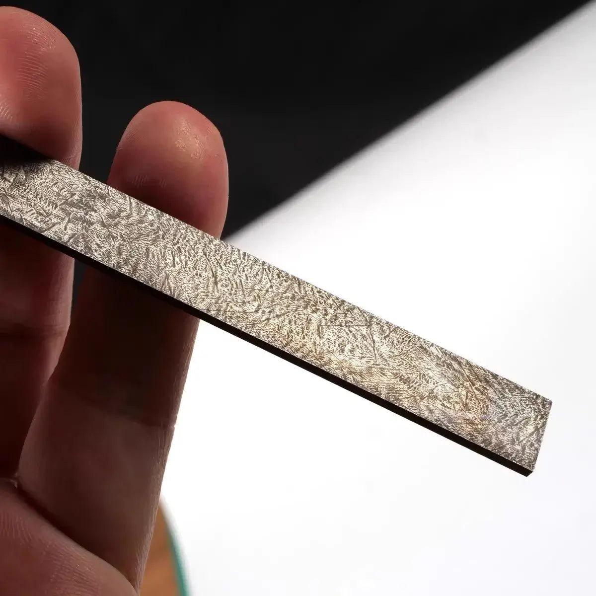Wootz Steel Knife Making Damascus Blanks displayed in hand, showcasing the intricate pattern and quality.