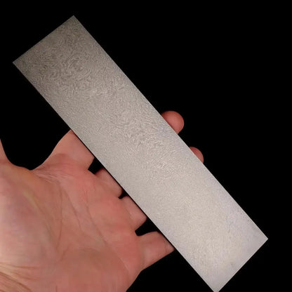Wootz Steel Knife Making Damascus Blanks shown in hand, displaying unique pattern and texture.